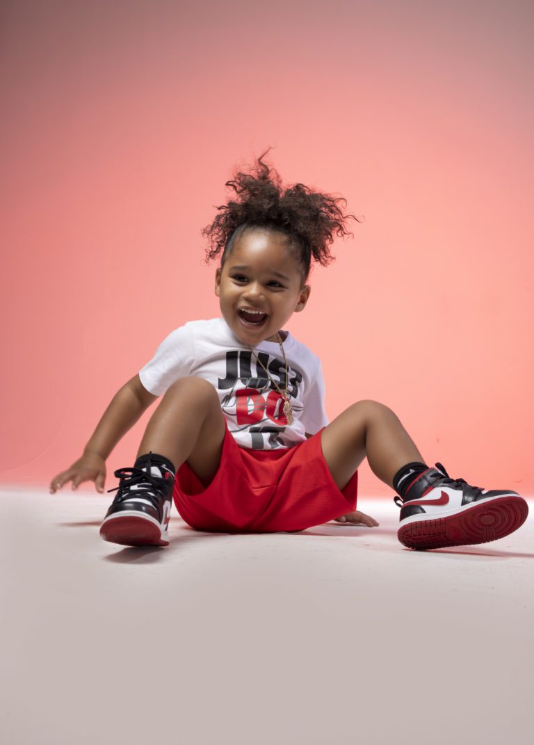 Young boy sitting on the floor in a photography studio