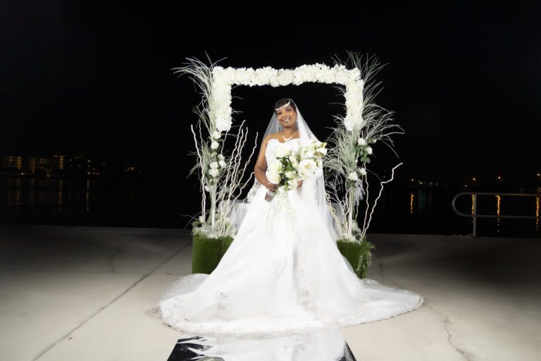 Bride in her wedding dress in front of a square arch