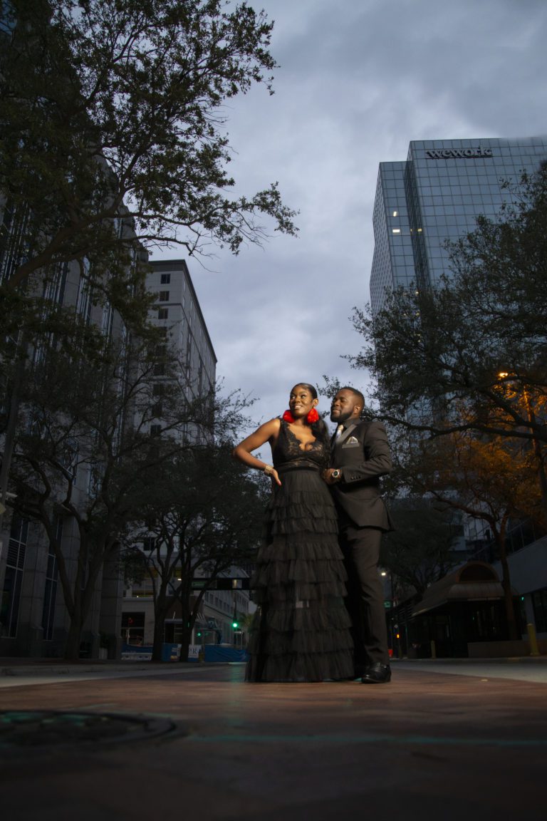 Couple standing between two buildings